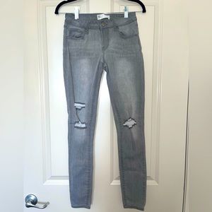 Moderately worn Tillys RSQ Ibiza skinny grey ripped jeans in a size 3